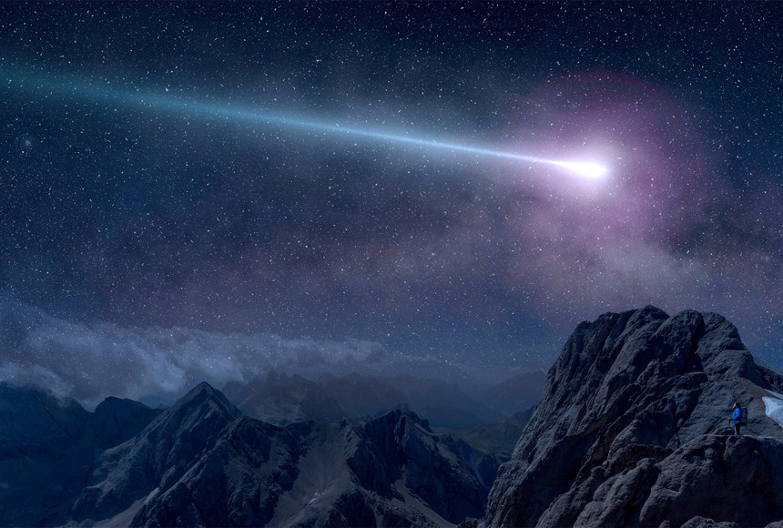 A purple shooting star at night over the mountain range