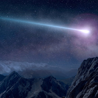 A purple shooting star at night over the mountain range